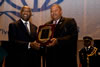 His Excellency Mr. Laurent Gbagbo, President of the Republic of C�te d'Ivoire, receiving an "Excellence Leadership Award" from the G-77 Chair, The Honourable W. Baldwin Spencer, Prime Minister and Minister for Foreign Affairs of Antigua and Barbuda.